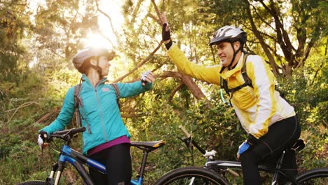 mountain biking couple giving high five