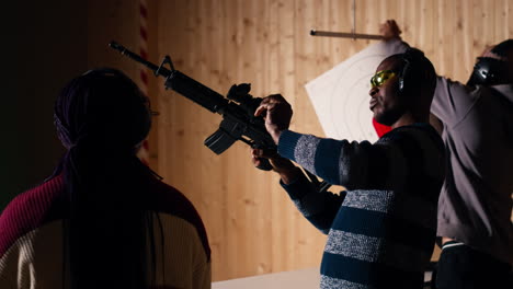 group of friends in firing range shooting targets, wearing earmuffs