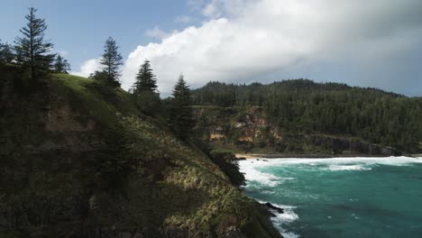 4K-Aerial---Norfolk-Island,-Australia-Slow-push-in-past-coast-line-to-reveal-beach-in-a-cove-DJI-Inspire-2