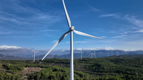 aerial view of windmill with large blades rotating on a windy day in countryside