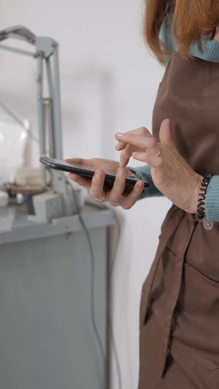 Person using a smartphone in a workshop