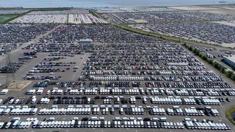wide aerial shot of new vehicles prepared for import and export at humber estuary industrial port england