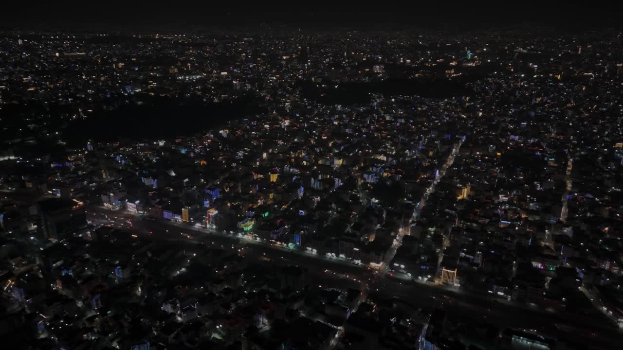 Aerial night footage of Kathmandu city during Diwali (Tihar), featuring the illuminated Dharahara Tower and glowing skyline filled with festive lights, showing Nepal’s vibrant cultural celebration