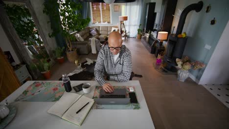 man working from home in a modern living room