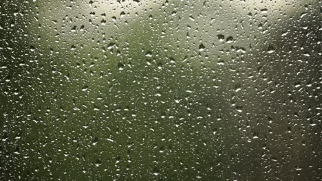 close up: raindrops on a window in the summer