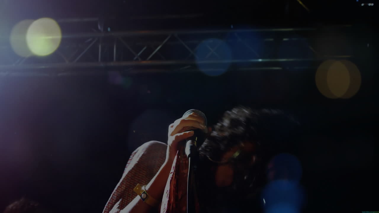 Singing into microphone, performer with dynamic lighting and lens flare animation