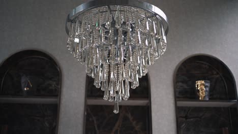 Elegant-crystal-chandelier-with-intricate-design,-hanging-in-a-sophisticated-interior-setting