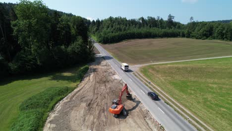 Aerial-View-Of-Excavator-Levelling-Ground-In-Preparation-For-New-Road-In-Switzerland