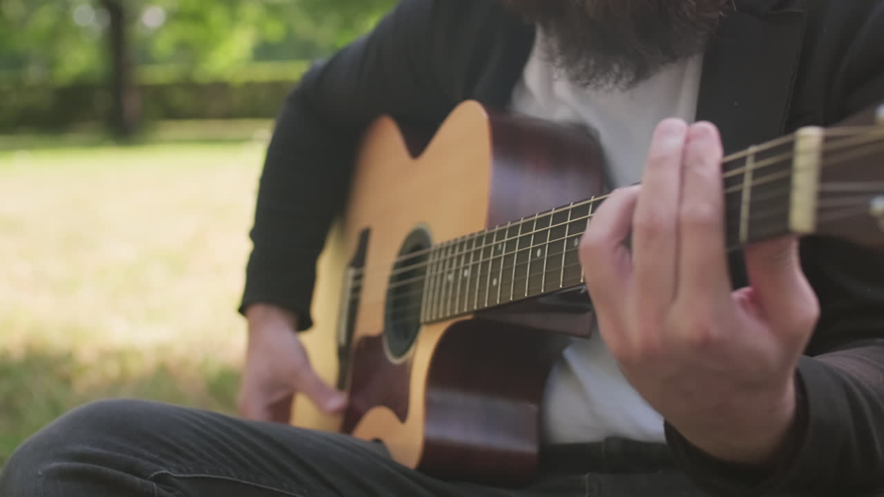 Close Up of Musician Playing Guitar Outdoors