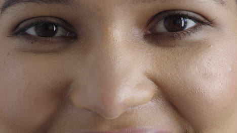 close up young woman eyes looking happy smiling at camera