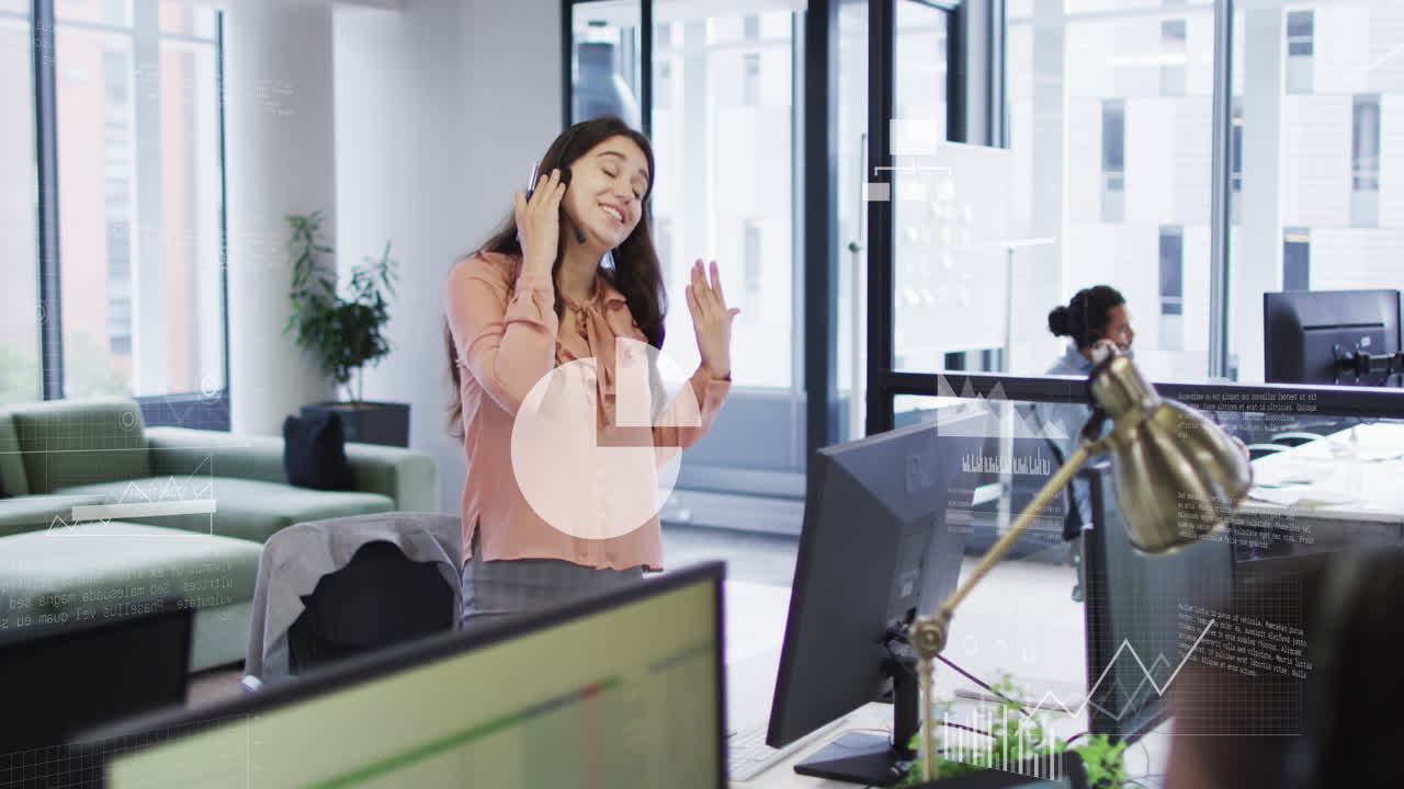 Animation of icons, graphs, map, computer language, caucasian female talking on videocall in office