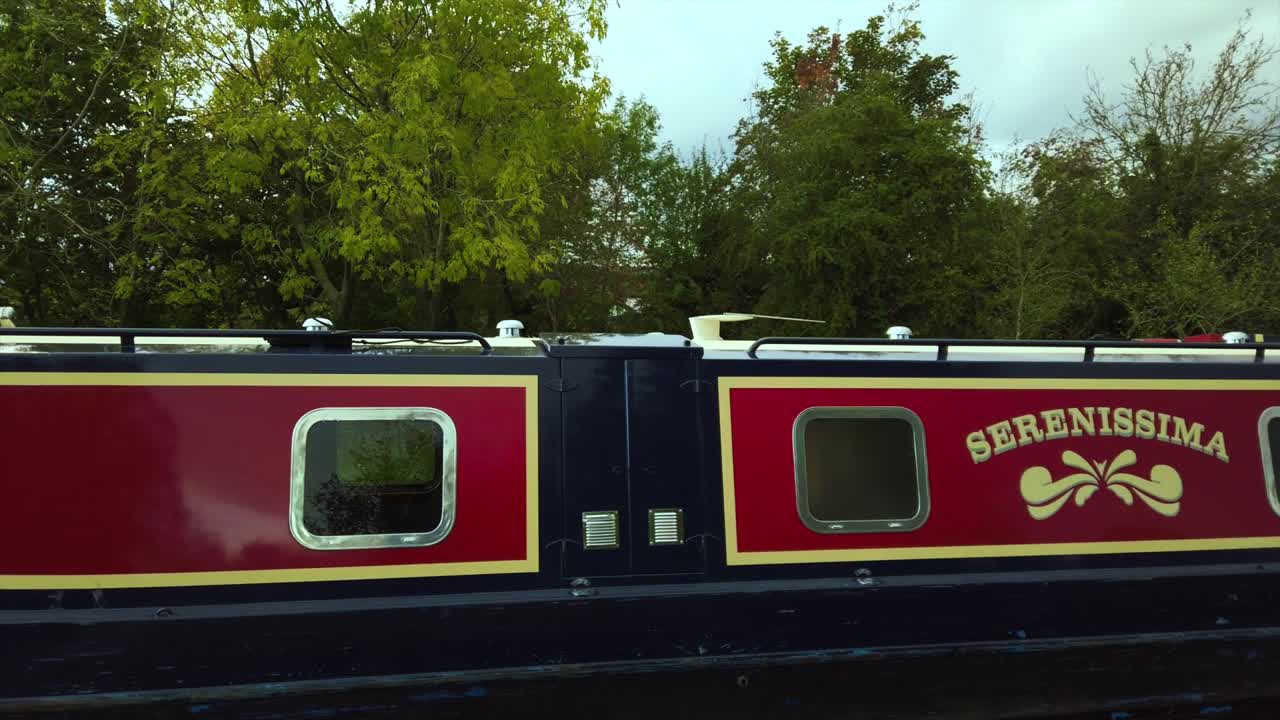 Family Living on boathouse sailing on a canal with dog