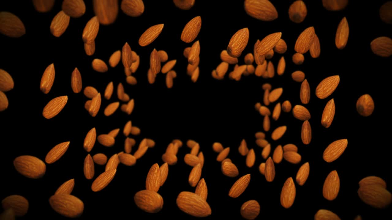 Flying many almonds nuts on black background. Foodstuff, Healthy food, Diet. 3D animation of almond rotating. Loop animation.