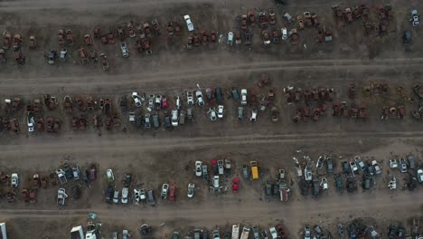 aerial cenital shot left to right from a abandonated car junk