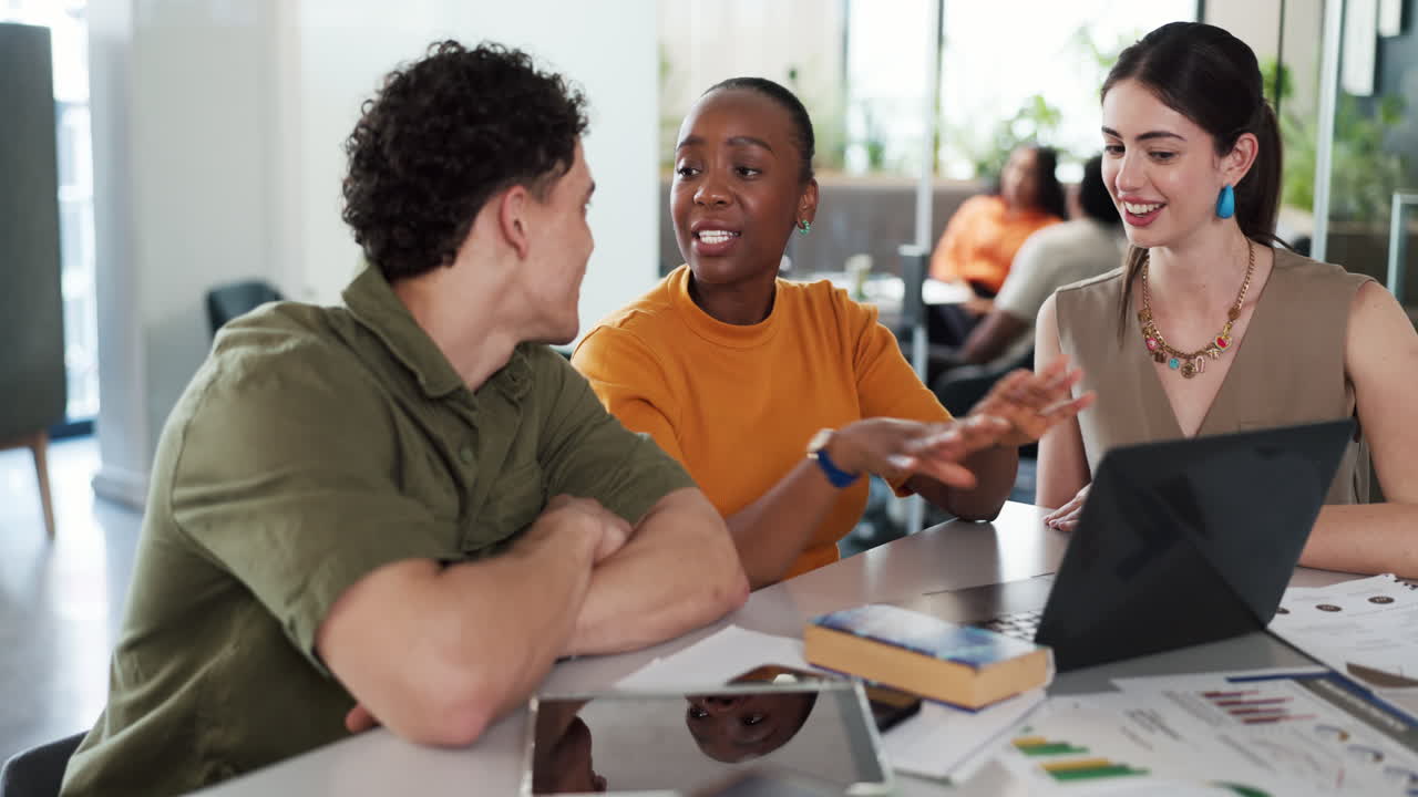 Diverse Business Team Collaborating on Laptop in Modern Office