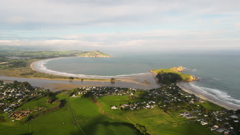 coast of karitane town and huriawa peninsula, south island, new zealand, aerial view