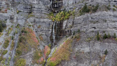 bridal veil falls waterfall cascading on mountain cliffs in utah, aerial