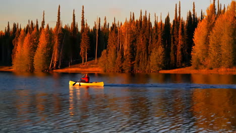 canoeing on a calm lake at sunset