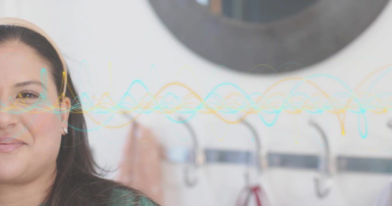 Mid adult woman standing by white wall showing voice UI with pulsing waveform syncing to speech