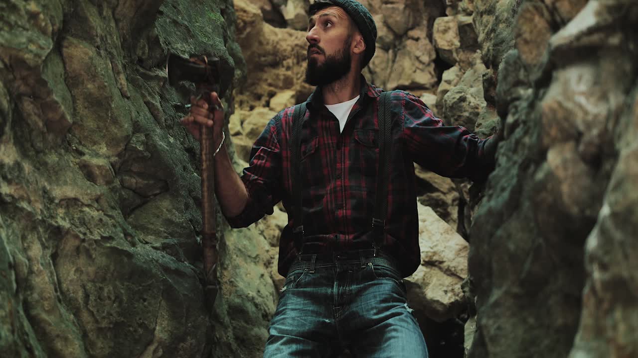 Lumberjack with axe in rocky environment