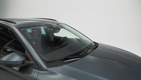 Windscreen-wiper-fluid-being-squirted-on-the-windscreen-and-wiped-clean-by-the-windscreen-wipers