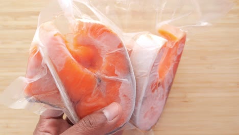 frozen salmon fillets in vacuum sealed plastic wrap