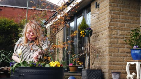 Attractive-woman-gardening-basket-of-flowers-in-medium-zoom-shot-slow-motion-portrait