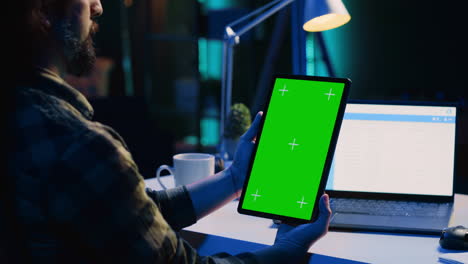man working from home doing project research, typing on mockup tablet
