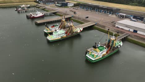 aerial drone shot of fishing boats docked at the sea lock at stellendam