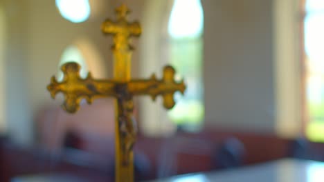 rack focus of christ on a cross alter ornament in a church