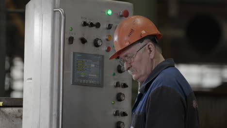 factory worker monitoring industrial machinery