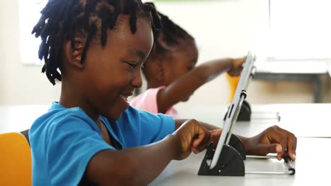 boy using digital tablet in classroom