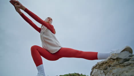 strong woman squatting nature training healthy body flexibility bottom view.