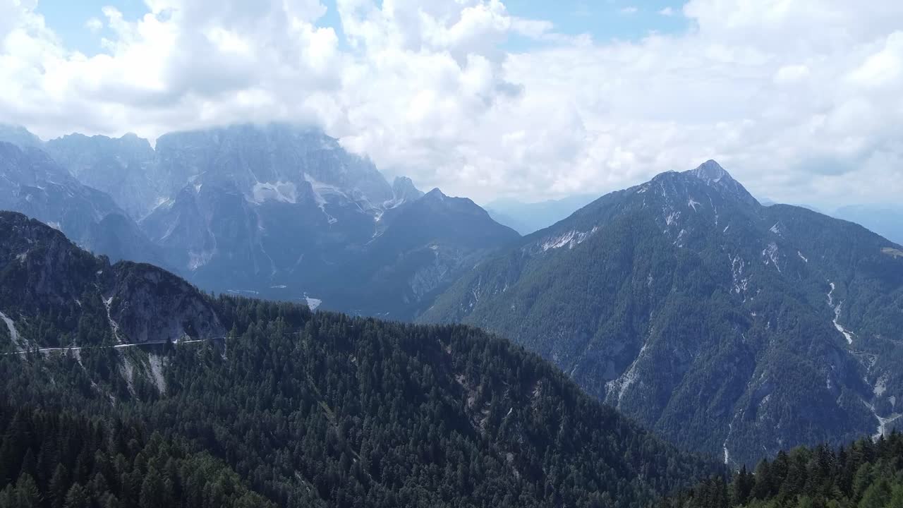 High peaks of Dolomites above clouds, aerial drone view