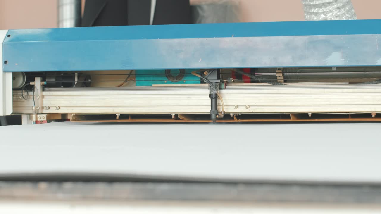 CNC machine for cutting fabrics textile materials and leather, laser marking and measurement. Modern footwear production.