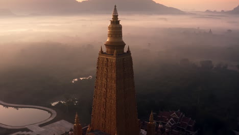 golden pagoda at sunrise in misty landscape