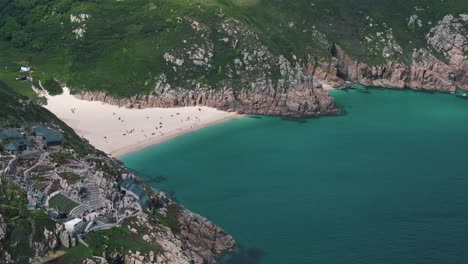 ascending circle right above minack theatre with beach in view