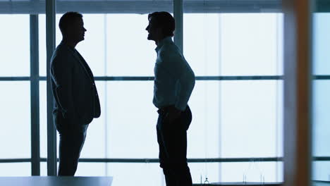 silhouette-business-people-handshake-meeting-in-corporate-office-for-partnership-deal-greeting-client-shaking-hands-welcoming-in-office-4k