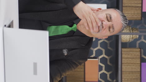 Vertical-video-of-Sleepy-businessman-yawns-looking-at-camera.