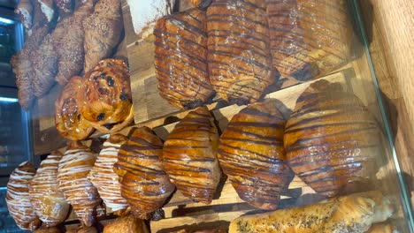 display-with-Spanish-pastries,-croissants-and-sweet-Neapolitans-vertical-view