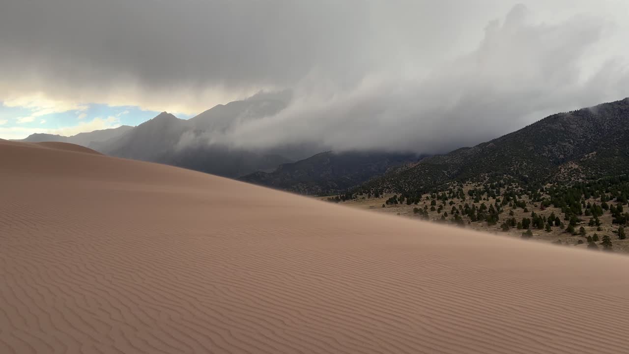 Windy Great Sand Dunes National Park Spring summer stormy foggy cloudy raining mist Crestone Needle peak Colorado Sangre de Cristo range Rocky Mountains magical large amounts of sand dune hills static