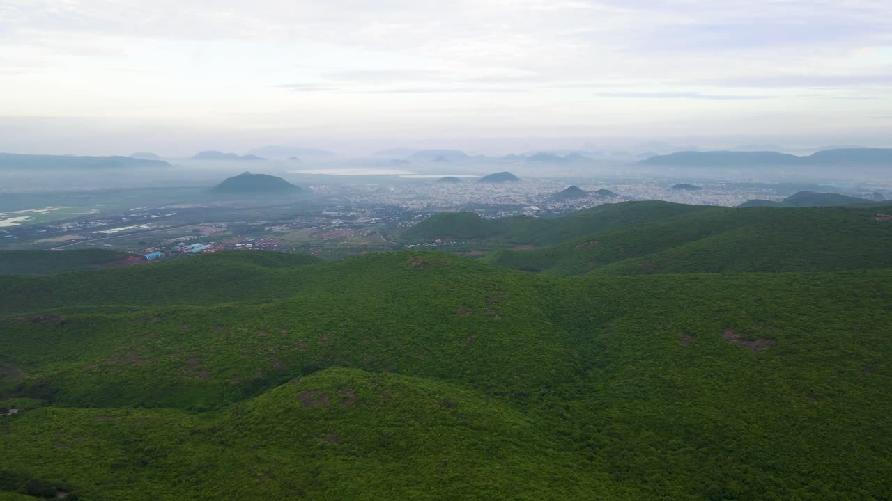 Aerial drone shot of Vizag city, with its bustling urban landscape stretching along the serene coastline of the ocean.