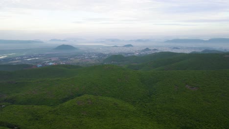 aerial drone shot of vizag city, with its bustling urban landscape stretching along the serene coastline of the ocean.