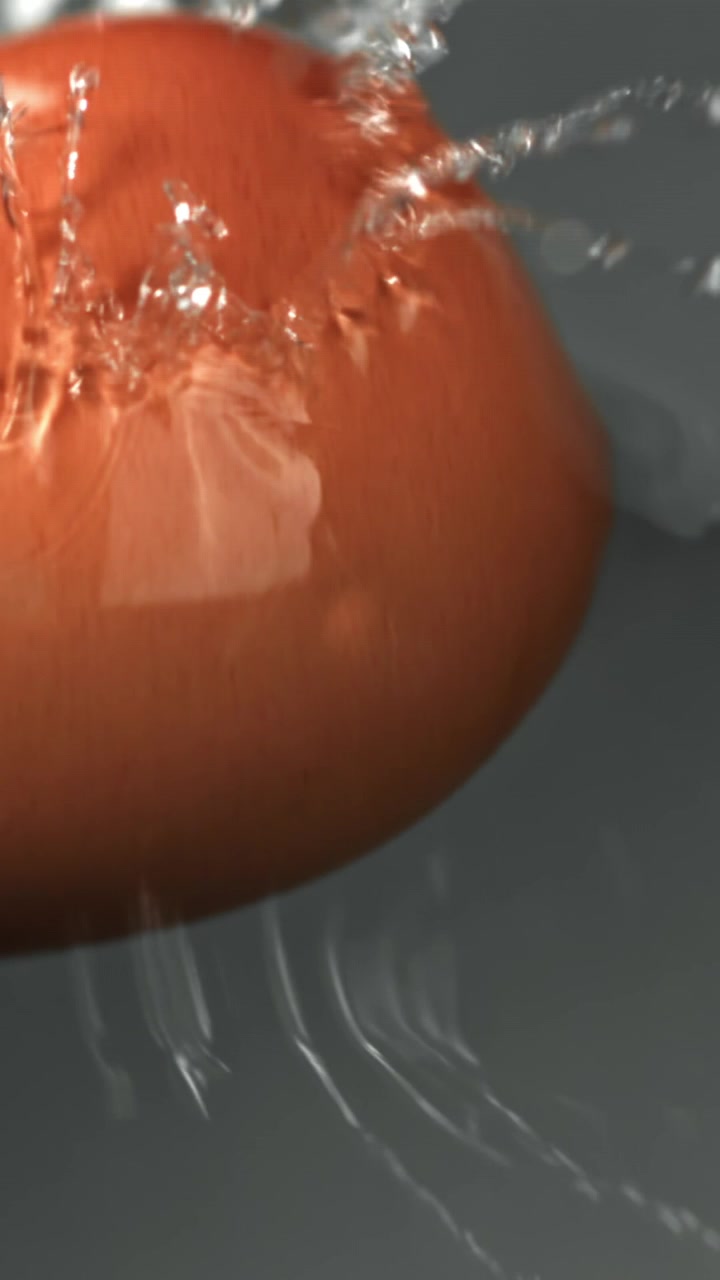 Fresh Tomato Splashing into Clear Water in Slow Motion