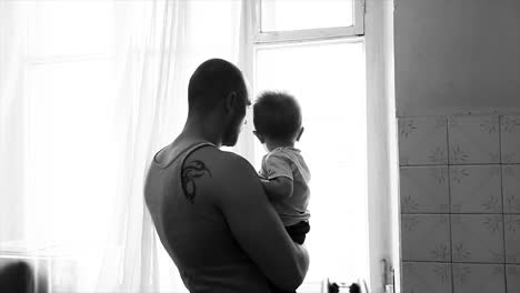 father and son at the window