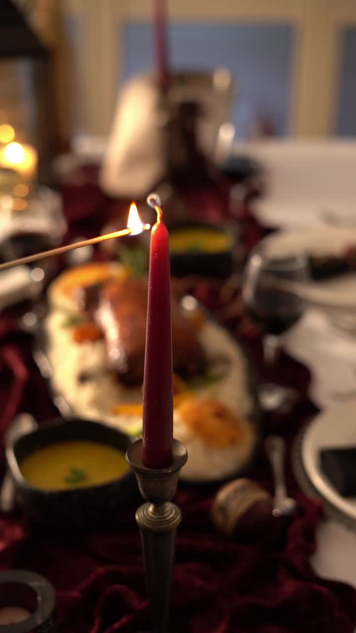 A woman lights a candle for a romantic sit, close up shot, insert shot