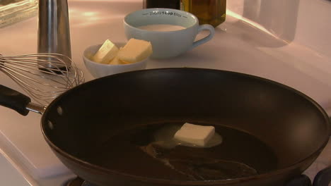 a cube of butter melts in a skillet