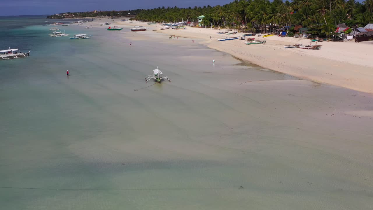 Camotes islands Philippines with Bangka traditional boats along the shore, Aerial dolly out reveal shot