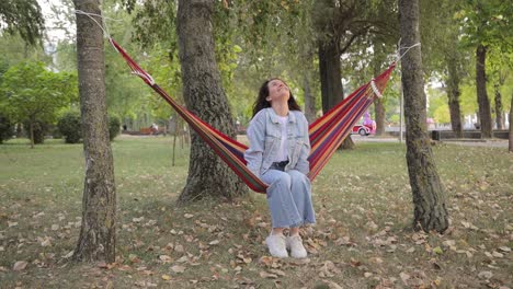 woman relaxing in a hammock in a park