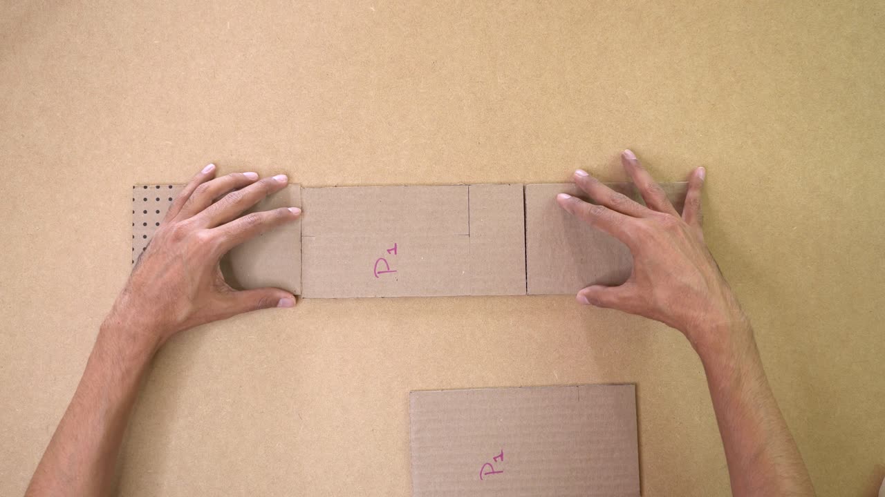 Hands craft with cardboard in creative process on tabletop
